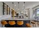 Open-concept kitchen featuring a large island with bar seating and modern appliances at 13420 Lafayette St, Thornton, CO 80241