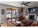 Cozy living room with fireplace, large window, and leather sofa and chairs at 13420 Lafayette St, Thornton, CO 80241