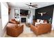 Inviting living room features a fireplace, TV, and stylish leather furniture at 13420 Lafayette St, Thornton, CO 80241