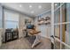Office with a large window, shelving, modern desk, neutral walls, and carpeted floors at 13420 Lafayette St, Thornton, CO 80241