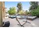 Backyard oasis featuring a swimming pool, hot tub, lounge chairs, and a hammock at 751 Poplar St, Denver, CO 80220