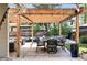 Backyard showcasing an outdoor dining area beneath a pergola and comfortable lounge seating at 751 Poplar St, Denver, CO 80220