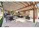 Backyard showcasing an outdoor lounge area under pergola, with a grill and dining space at 751 Poplar St, Denver, CO 80220