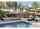 Resort-like backyard with a sparkling pool, spa, and a cozy lounge area with pergola at 751 Poplar St, Denver, CO 80220
