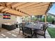 Backyard with a dining area under a pergola, plus lounge seating, pool and hot tub at 751 Poplar St, Denver, CO 80220