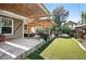 Backyard featuring a wooden pergola with seating, turf grass, and a fence at 751 Poplar St, Denver, CO 80220