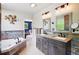 Elegant bathroom boasts a double sink vanity, soaking tub, and unique decorative accents at 751 Poplar St, Denver, CO 80220