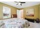 Bright bedroom with colorful paisley bedding, a ceiling fan, and built-in storage at 751 Poplar St, Denver, CO 80220