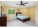 Bedroom with a ceiling fan, a window with natural light, and carpeted floors at 751 Poplar St, Denver, CO 80220