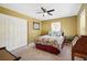 Cozy bedroom with a patterned comforter, ceiling fan, closet, and ample natural light at 751 Poplar St, Denver, CO 80220