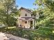 Inviting two-story home with a charming front porch and lush landscaping at 751 Poplar St, Denver, CO 80220