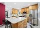 Bright kitchen with stainless steel appliances, marble counters, kitchen island, and black and white floors at 751 Poplar St, Denver, CO 80220