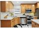 Modern kitchen with stainless steel appliances, marble countertops and backsplash, and black and white floors at 751 Poplar St, Denver, CO 80220