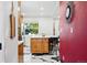 Kitchen with stainless steel appliances, a center island with seating, and stylish floors at 751 Poplar St, Denver, CO 80220