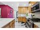 Modern kitchen with marble countertops, stainless steel appliances, and black and white floors at 751 Poplar St, Denver, CO 80220