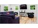 Bright living room with hardwood floors, comfortable seating, and a modern entertainment setup at 751 Poplar St, Denver, CO 80220