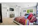 Spacious main bedroom with a decorative bed, TV, ceiling fan, and a comfortable seating area at 751 Poplar St, Denver, CO 80220