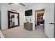 Bright main bedroom featuring a large mirror, TV, ceiling fan, and a walk-in closet at 751 Poplar St, Denver, CO 80220