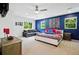Spacious main bedroom with blue accent wall, plush carpeting, and ample natural light at 751 Poplar St, Denver, CO 80220