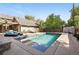 A refreshing swimming pool is surrounded by lounge chairs and a pergola for outdoor relaxation at 751 Poplar St, Denver, CO 80220