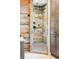 Walk-in shower with stylish wood-look tile, a rain shower head, and matte black fixtures at 751 Poplar St, Denver, CO 80220