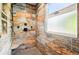 Modern shower featuring stylish wood-look tiling and sleek black fixtures at 751 Poplar St, Denver, CO 80220