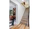 Stylish staircase featuring hardwood and patterned-tile steps, leading to an office space with custom shelving at 751 Poplar St, Denver, CO 80220