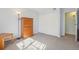 Well-lit room with closet and light wood dresser, featuring light walls and carpeted floor at 1795 S Pitkin St # B, Aurora, CO 80017