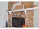 Close up of the stone fireplace featuring a white mantle and decorative accents at 1795 S Pitkin St # B, Aurora, CO 80017