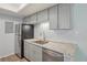 Updated kitchen with stainless appliances, granite countertops, and sleek gray cabinetry at 1795 S Pitkin St # B, Aurora, CO 80017
