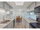 Well-lit kitchen featuring granite countertops, stainless appliances and gray cabinetry at 1795 S Pitkin St # B, Aurora, CO 80017