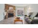 Cozy living room featuring a stone fireplace and sliding glass doors to a private balcony at 1795 S Pitkin St # B, Aurora, CO 80017