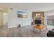 Bright and spacious living room with a stone fireplace and sliding glass doors to the balcony at 1795 S Pitkin St # B, Aurora, CO 80017