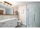 Modern bathroom with double vanity and a large walk-in shower at 6062 Garrison St, Arvada, CO 80004