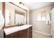 Bathroom with vanity, mirror, and shower/tub combo at 6062 Garrison St, Arvada, CO 80004