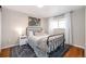 Bright bedroom with metal bed frame and a neutral color scheme at 6062 Garrison St, Arvada, CO 80004