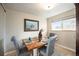 Charming dining area with wood table and four gray chairs at 6062 Garrison St, Arvada, CO 80004