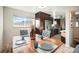 Dining area with wood table and view into kitchen at 6062 Garrison St, Arvada, CO 80004