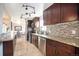 Modern kitchen with dark wood cabinets and granite counters at 6062 Garrison St, Arvada, CO 80004