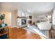 Living room features hardwood floors, fireplace, and view of kitchen at 6062 Garrison St, Arvada, CO 80004