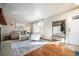 Bright living room with hardwood floors and fireplace at 6062 Garrison St, Arvada, CO 80004