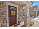 Inviting front entrance with a wreath and stonework at 9760 Mayfair St # A, Englewood, CO 80112