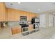 Modern kitchen with stainless steel appliances and tile counters at 9760 Mayfair St # A, Englewood, CO 80112