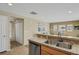 Kitchen with double sink, stainless steel appliances, and tile flooring at 9760 Mayfair St # A, Englewood, CO 80112