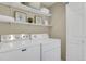 Laundry room with washer, dryer, and shelving at 9760 Mayfair St # A, Englewood, CO 80112