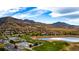 Panoramic aerial view of a community with a golf course, lake, and mountain views at 16671 Red Cliff Cir, Morrison, CO 80465
