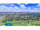 Aerial view of a residential area with a golf course and scenic views at 16671 Red Cliff Cir, Morrison, CO 80465