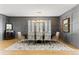 Formal dining room featuring panelled walls, modern chandelier, and large windows with shutters at 16671 Red Cliff Cir, Morrison, CO 80465