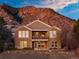Large two-story home with mountain backdrop and a covered patio at 16671 Red Cliff Cir, Morrison, CO 80465