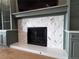 Close-up of a modern fireplace with a striking herringbone tile surround and custom built-in cabinetry at 16671 Red Cliff Cir, Morrison, CO 80465